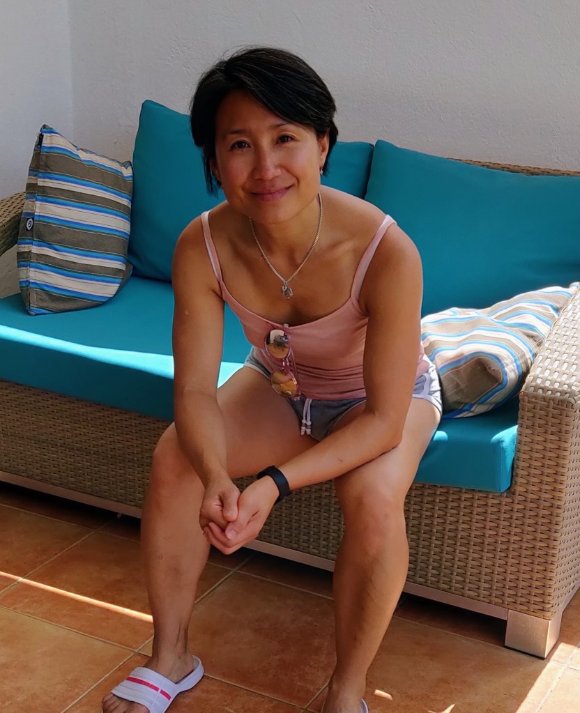 Photo of Hanh sitting on garden sofa